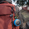 Orba by Artiphon Blue Silicone Sleeve hanging from a backpack